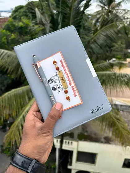 This Rakhi gift set features the Orion diary in a stylish grey. The combo includes the personalized A5 diary, a Krysta pen, and a Rudraksh rakhi, both of which can be engraved with a name.
