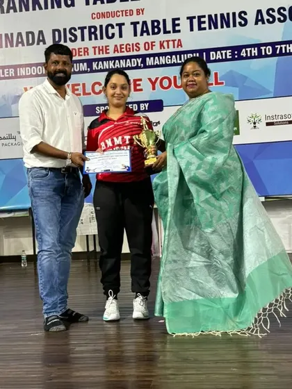 Our player Deshna receiving her trophy for winning the women's title at the state ranking tournament in Mangalore.