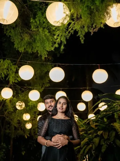 A romantic pre-wedding photo under a canopy of paper lanterns. Night shoots offer a chance to play with light for a magical effect.