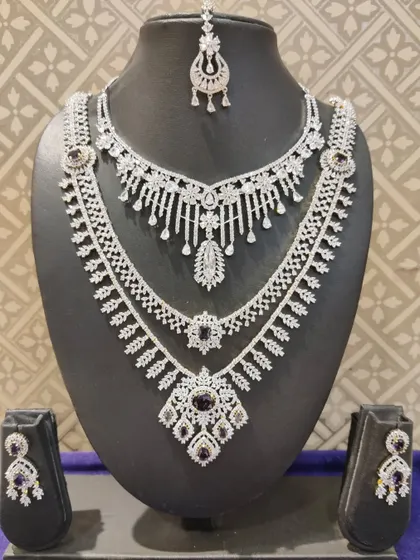 A layered American diamond necklace set with deep purple stones, a unique and royal color choice.