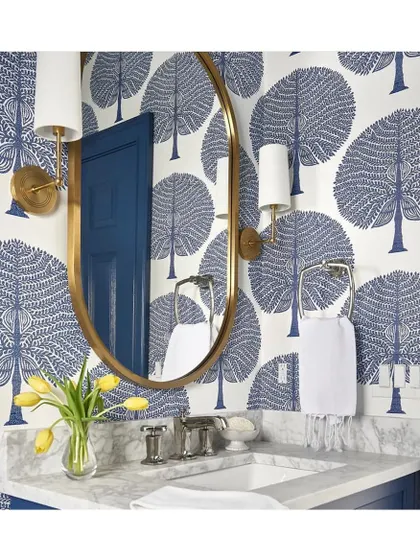 This 'Mulberry' tree wallpaper in a classic blue and white exudes style and sophistication. Paired with a gold mirror and modern fixtures, it creates a powder room that is both fresh and timeless.