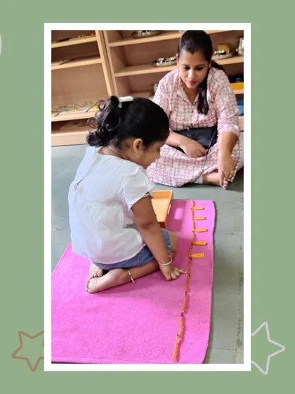 Viha works with number rods, a classic Montessori material for understanding quantity and sequence. Her mother observes as she builds a concrete foundation for mathematical understanding.