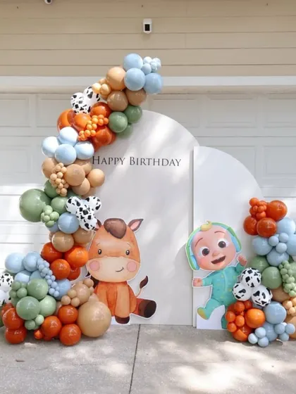 A playful Cocomelon and farm animal theme, combining characters from the popular show with cute horse and cow details for a fun and colorful birthday backdrop.