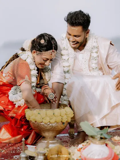 Laughter during a wedding ritual, a candid moment that shows the fun and joy of the ceremony.