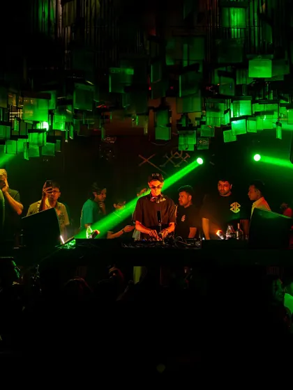 The view from the console at M Bar Kitchen in Kolkata. The green lights and packed crowd set the stage for a serious throwback session.
