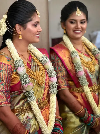 A lovely portrait with her wedding garlands. The makeup is balanced to not compete with the elaborate floral arrangements.