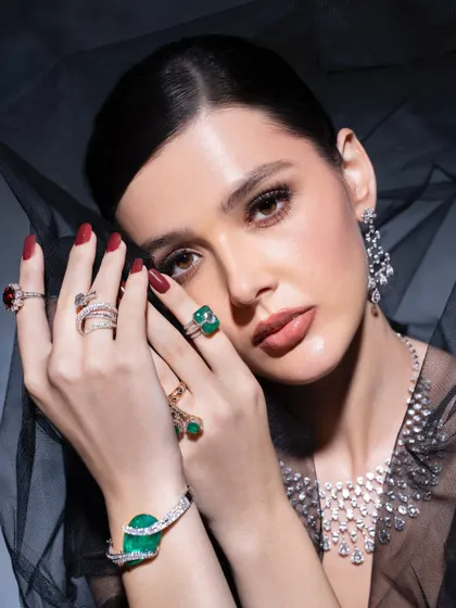 A close-up shot focusing on the hands and jewellery. I believe accessories are a woman's armor, and this image captures that strength, showcasing a stunning emerald bracelet and multiple rings.