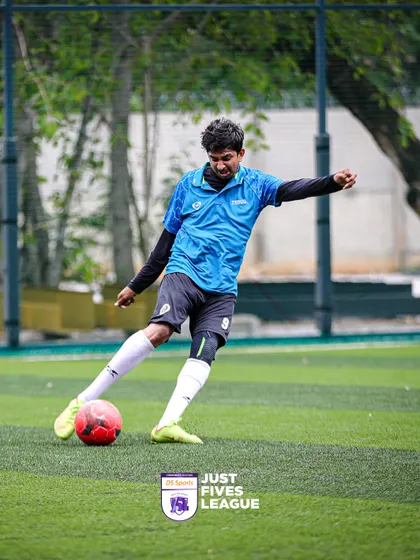 A player from a corporate team executes a powerful kick during a match. These action shots capture the dynamic and fast-paced nature of five-a-side football.
