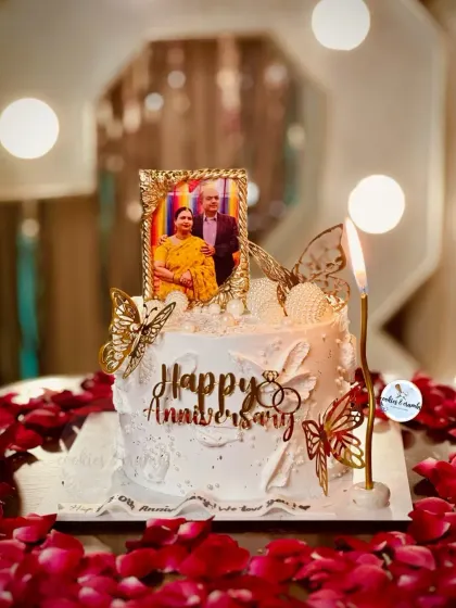 Celebrating 30 years of love with this special anniversary cake. It features an edible photo frame, golden butterflies, and delicate details, all set against a backdrop of romantic rose petals.