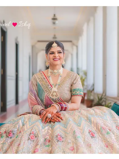 A full portrait of the bride looking absolutely radiant. Her custom pastel polki set was the perfect choice for her destination wedding in Jaipur.