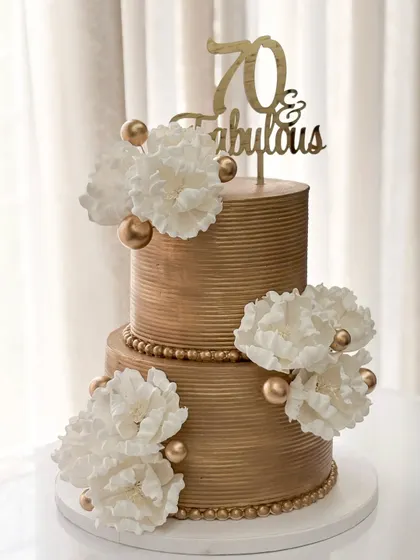 Seventy and fabulous! I adapted my classic golden tiered design with large, handmade white sugar peonies for a sophisticated and timeless 70th birthday cake.