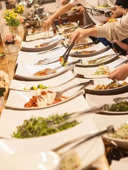 Guests enjoying a lavish banquet spread with a wide variety of dishes.