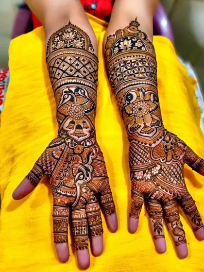 This design combines floral, peacock, and geometric patterns in a beautiful composition. The different elements flow into each other seamlessly from the fingers to the mid-arm.