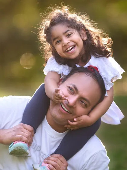 Pure joy and a beautiful dimpled smile. I focus on capturing these candid, interactive moments during family sessions that truly show the love and playfulness in your relationship.