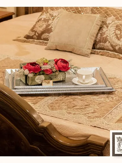 Another take on morning elegance, this silver-finished tray brings a touch of glamour to the bedside. Paired with a classic carved wooden bed frame, it creates a feeling of everyday luxury.