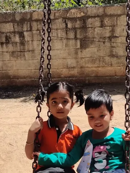 Friends enjoying the swings at the park. Outdoor play allows for important social development as children learn to share, take turns, and communicate with their peers.