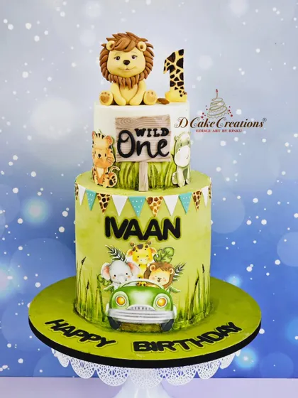 A clean studio shot of the two-tier "Wild One" cake, highlighting the hand-painted details and the cute lion topper.