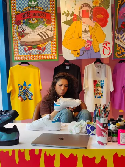 My workstation during the Bangalore pop-up, surrounded by my art prints and paints. Creating this vibrant, artistic corner within a retail space is part of the experience.