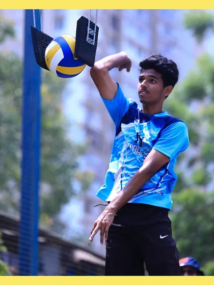 A player practices his arm swing and timing, getting ready to unleash a powerful hit on the stationary ball.