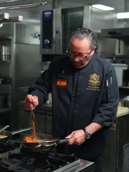 In my kitchen, every dish is prepared with cariño, or love. Here, I am preparing a sauce, ensuring that every ingredient speaks of its Spanish heritage and contributes to a memorable flavour.