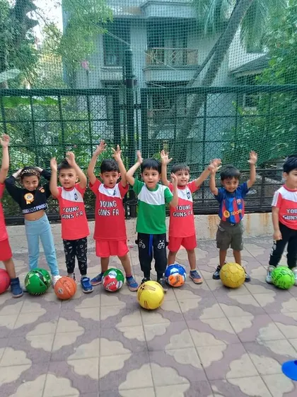 Ending each session on a high! A group of toddlers raises their hands in celebration after a great class.