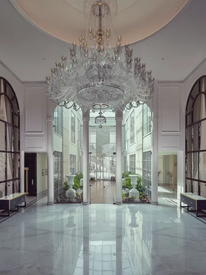 The heart of a home should inspire awe. In this grand foyer, we used soaring ceilings, a magnificent crystal chandelier, and pristine marble floors to create an entrance that is both monumental and welcoming. It is a space that sets the tone for the entire residence, reflecting a life of elegance and sophistication.