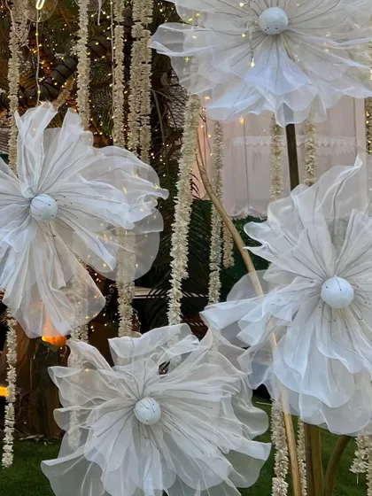 A close-up of the delicate, handcrafted origami flowers, each lit from within, showcasing the artistry and craftsmanship involved.