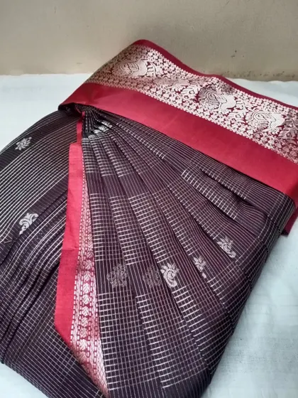 A unique black saree with red border and silver stripes. I take care to align the pleats with the saree's pattern for a cohesive look.