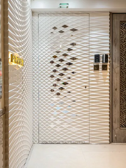 A detailed shot of the Corian door, showing the precision of the 3D wavy texture and the subtle cutouts that add depth. This design is perfect for clients who appreciate modern minimalism and clever design.