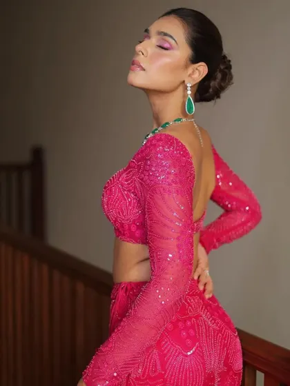 A contemporary look from Mishru, styled in a vibrant magenta pink. The mermaid-style skirt and full-sleeved blouse create a sleek and modern silhouette, perfect for a cocktail party or sangeet.