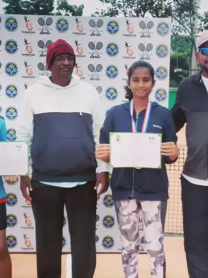 The winner and runner-up of a girls' category event at the AITA TS7 U-14 tournament with their medals and certificates.