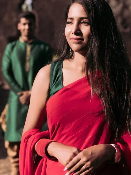 A thoughtful portrait of the bride-to-be, with her partner standing softly out of focus in the background. This composition tells a story of love and contemplation.