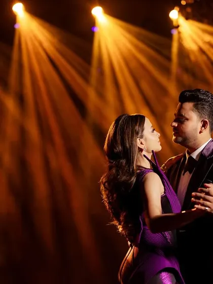 Another look at the couple's first dance, showcasing the groom's custom velvet tuxedo and the bride's elegant gown, perfectly capturing the romantic, high-energy mood of the event.