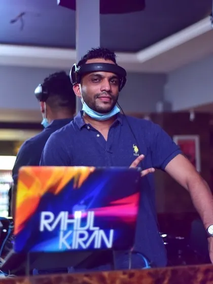 A moment behind the decks with my custom branded laptop. I believe in professionalism and bringing a polished setup to every gig.
