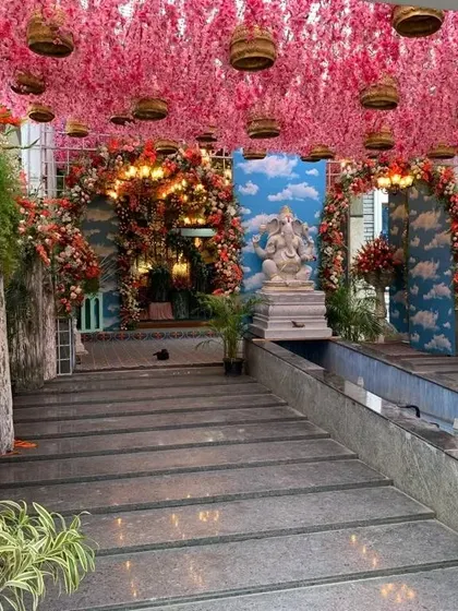 Another angle of the grand naming ceremony entrance, showing the Ganesha statue and the path leading into the hall. The decor creates a seamless, immersive experience for guests.