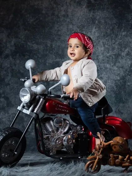 Our little biker, complete with a red bandana, looking every bit the part. These fun costume details are what make the photos so special.