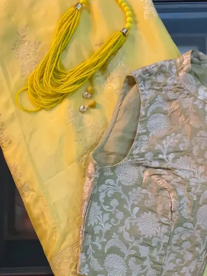 The styling for our yellow Pure Butter Silk saree, paired with a Banarasi brocade blouse and a handmade yellow beaded necklace.