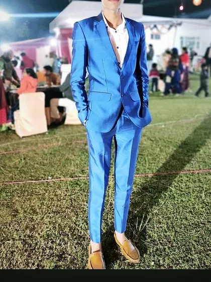 A client looking sharp in a vibrant electric blue suit at an outdoor event. I can create suits that stand out and make an impression.