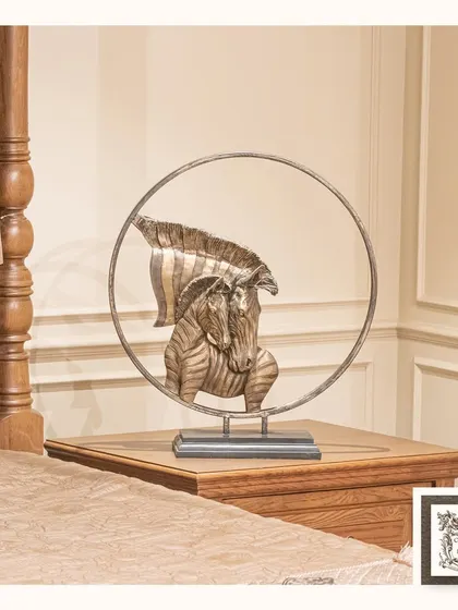 A sculpture that tells a story of motherly love, this piece features a mother and foal zebra in a protective embrace. It's a heartwarming and artistic addition to a bedside table or shelf.