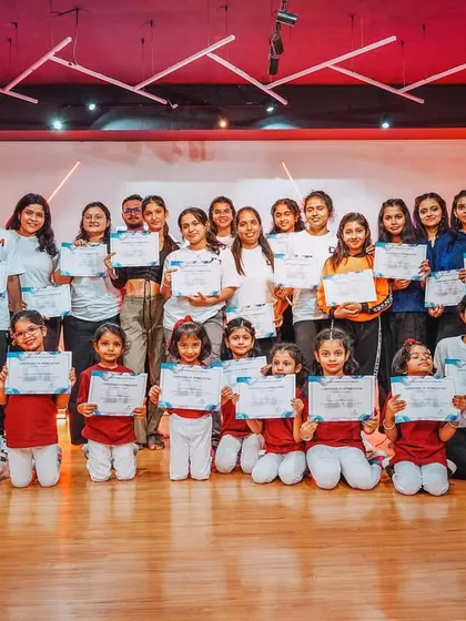 The full crew of performers at our Studio Showcase 2024. This group photo captures the joy and sense of accomplishment of our junior, senior, and adult dancers.