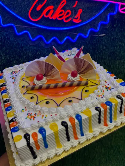 A fun, square-shaped Butterscotch cake with a colourful theme. The sides are decorated with multi-coloured icing, making it a cheerful and festive choice for any party.