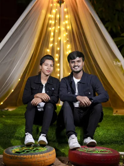 A cozy pre-wedding photo in a tent-like structure decorated with fairy lights. This setup is perfect for creating a warm and intimate feel.