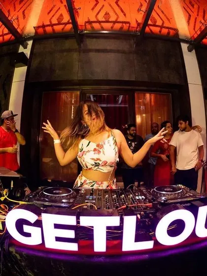 A fellow DJ takes over the decks at our GETLOUD Pool Party. It's a collaborative experience.