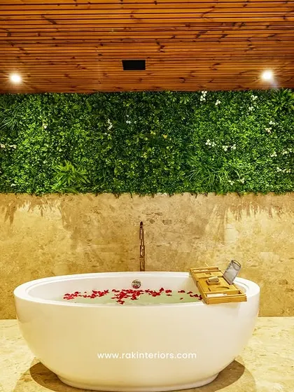 I designed this spa-like bathroom to be an escape for hotel guests. It features a freestanding tub, full-height wood-paneled walls, and a green wall accent to bring a touch of nature indoors, creating a serene and luxurious feel.