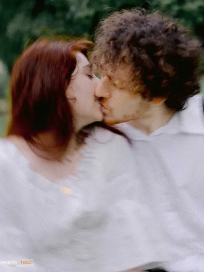 A blurry, artistic shot of a kiss, capturing the motion and whirlwind of emotion in that single, perfect moment.