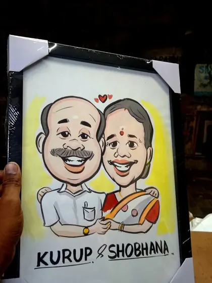 Another view of a framed couple's portrait, showing how the black frame complements the vibrant artwork inside.