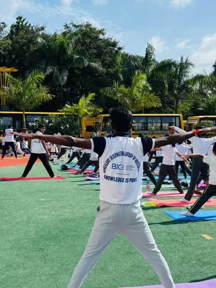 An instructor leads a group of students through various yoga poses, ensuring correct form and encouraging mindfulness during the session.