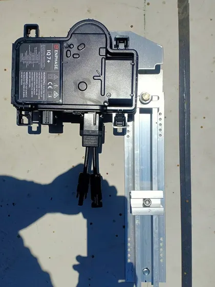 This is a microinverter from Enphase Energy, a technology that optimizes power generation for each individual panel. This is ideal for roofs that experience partial shading, as it ensures maximum output from the entire system.