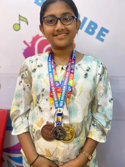 I am so proud of my student Aayushi, a chess champion from our academy. Here she is with her medals after winning first place at the Khel Mahotsav Chess Tournament. Her dedication is an inspiration to all of us.