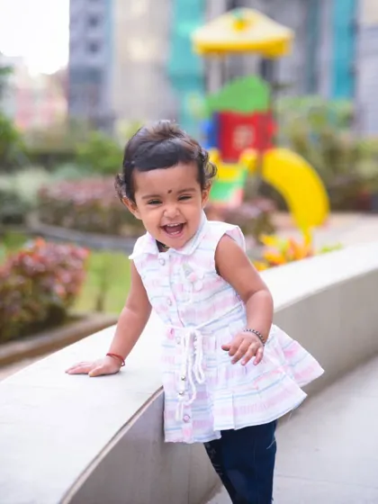 The pure, infectious laughter of a child is the best thing to capture. This little girl's happy expression is priceless.